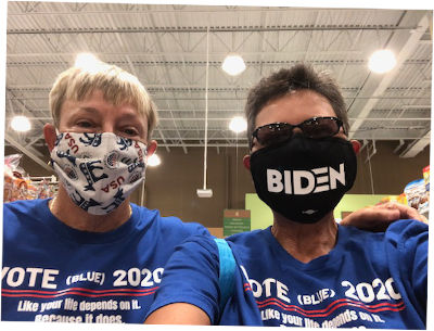 two women wearing democrat biden t-shirts and masks